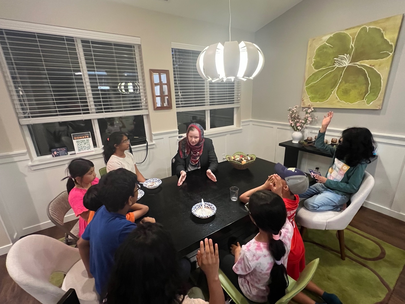 Children with hands raised at a house party