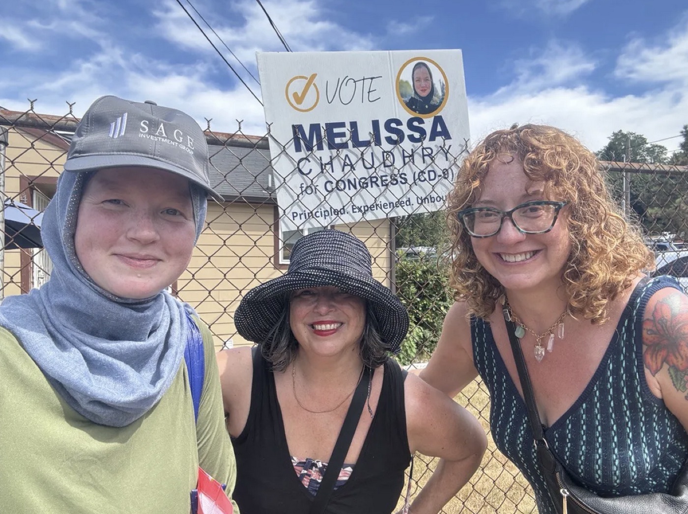 Melissa canvassing with volunteers in front of a campaign sign, 2024